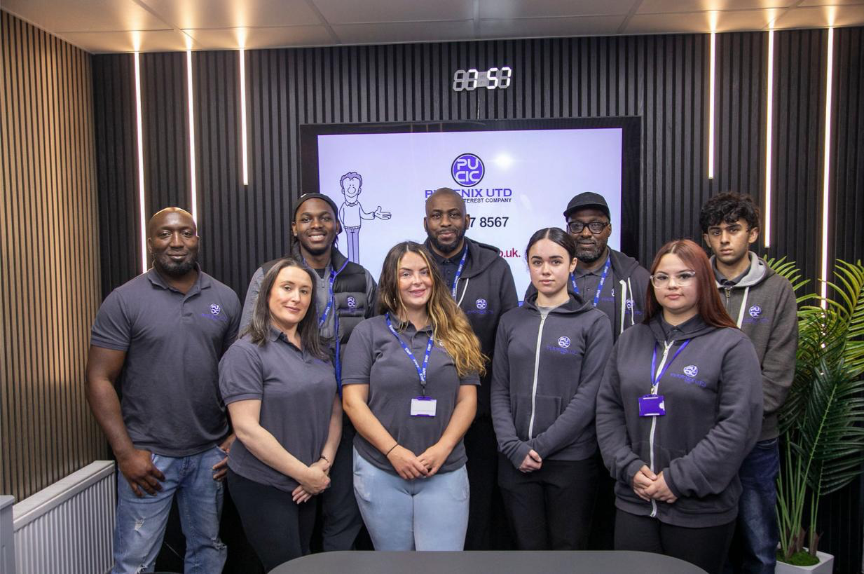 PUCIC team members standing together in a studio workspace